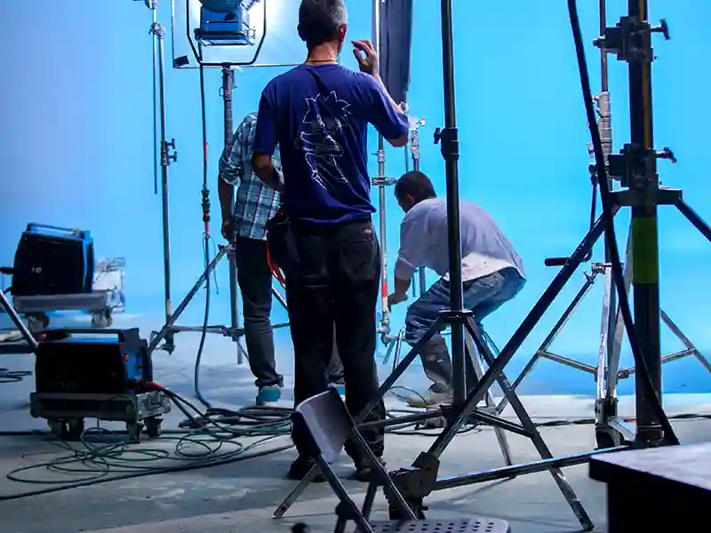 Man working in a studio with a blue chroma key