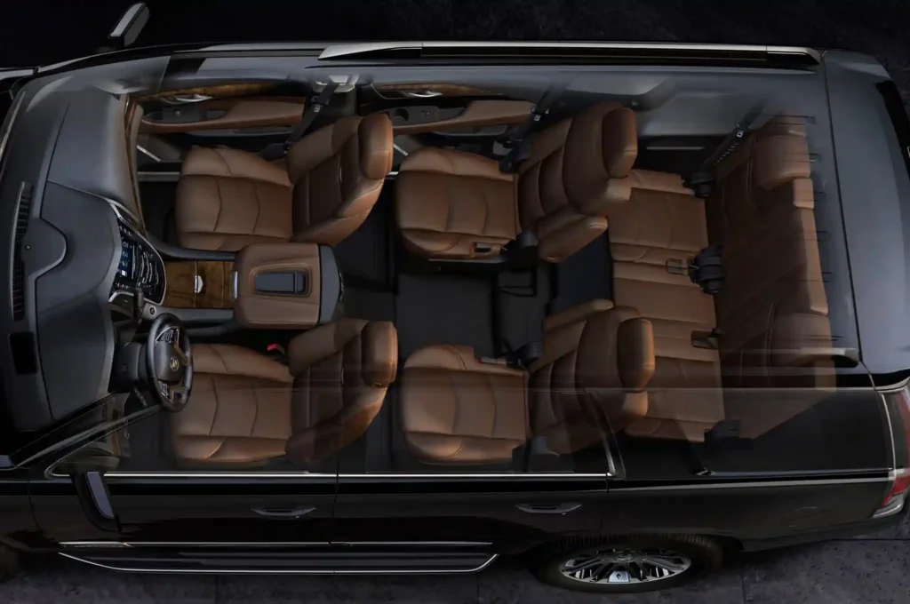 A top-down, transparent cutaway view of a black luxury SUV showing a spacious three-row interior with premium brown leather captain's chairs and wood-grain accents.