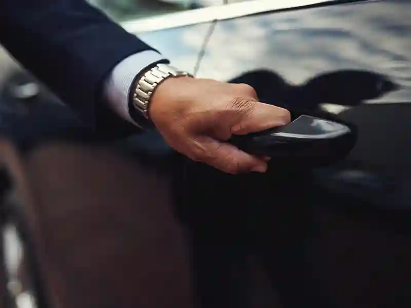 Close-up of a Chauffeur hand opening the back door