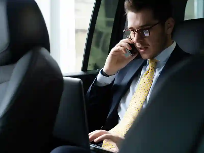 Man dressed in a black suit talking on his mobile