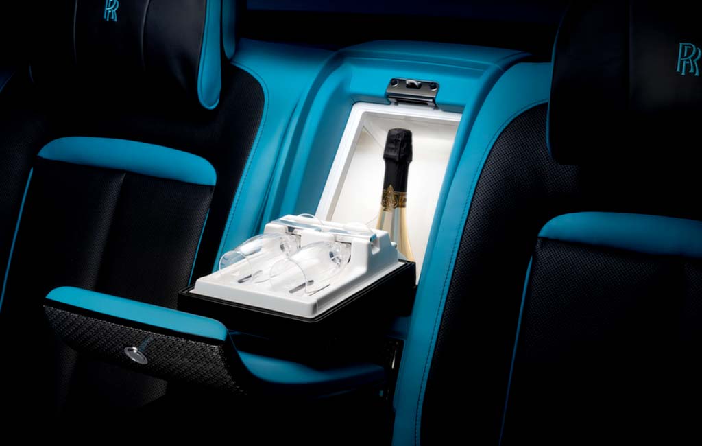 Back of the Rolls-Royce Ghost in leather blue interiors with a Champagne bottle