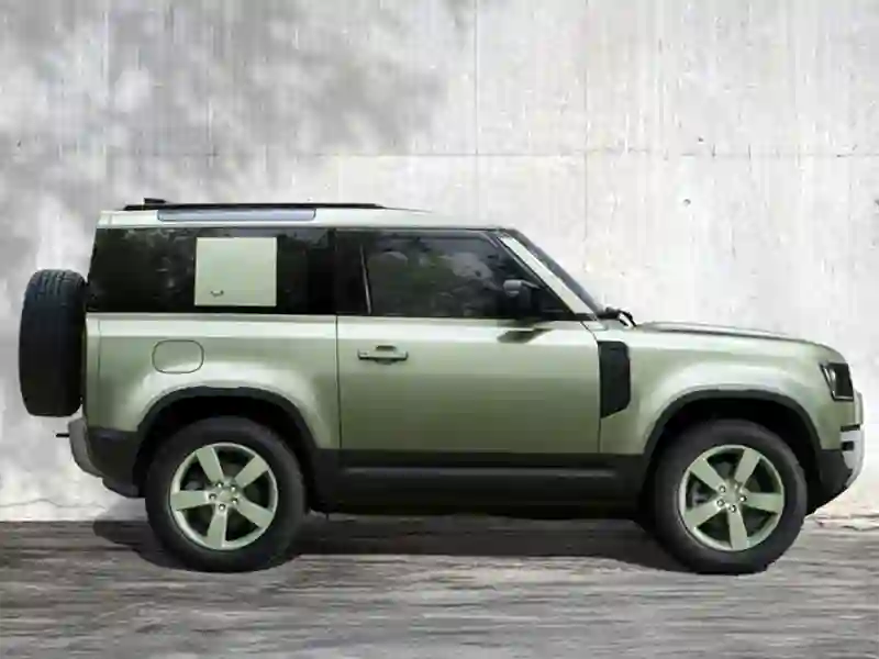 Side view of the green colour Land Rover Defender