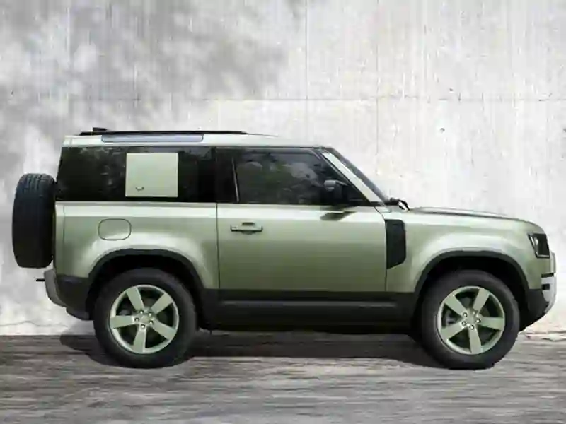Side view of the green colour Land Rover Defender