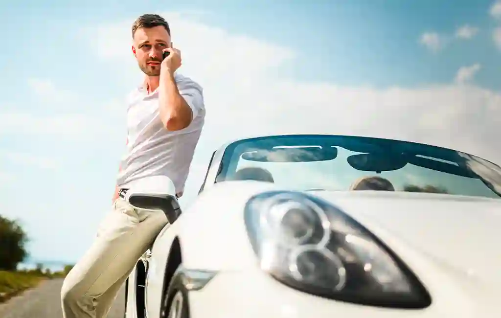 Business man next to a Supercar